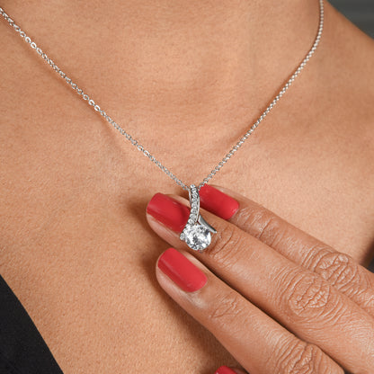 Allure necklace being worn on a person's neck with a hand holding it.